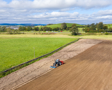 a New Holland Tractor Tilling A Fields Soil